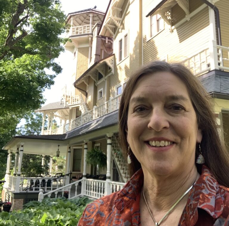 Nancy McCoy takes a selfie in front of Black Point Estate during her employment