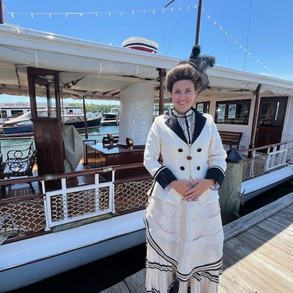 A woman standing in front of a boat